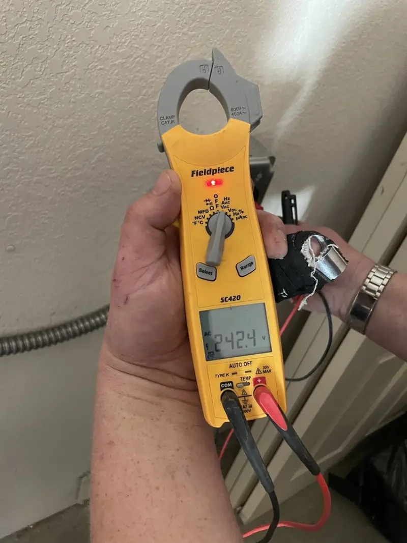 Voltage testing with clamp meter during Outlet Installation in Mulberry